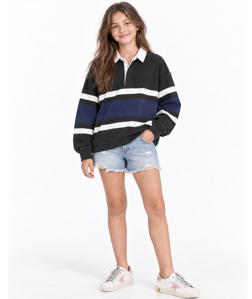 Tween model wearing the Vintage Havana Tween Heritage Stripe long-sleeve polo in green and blue with contrast stripes and a white collar
