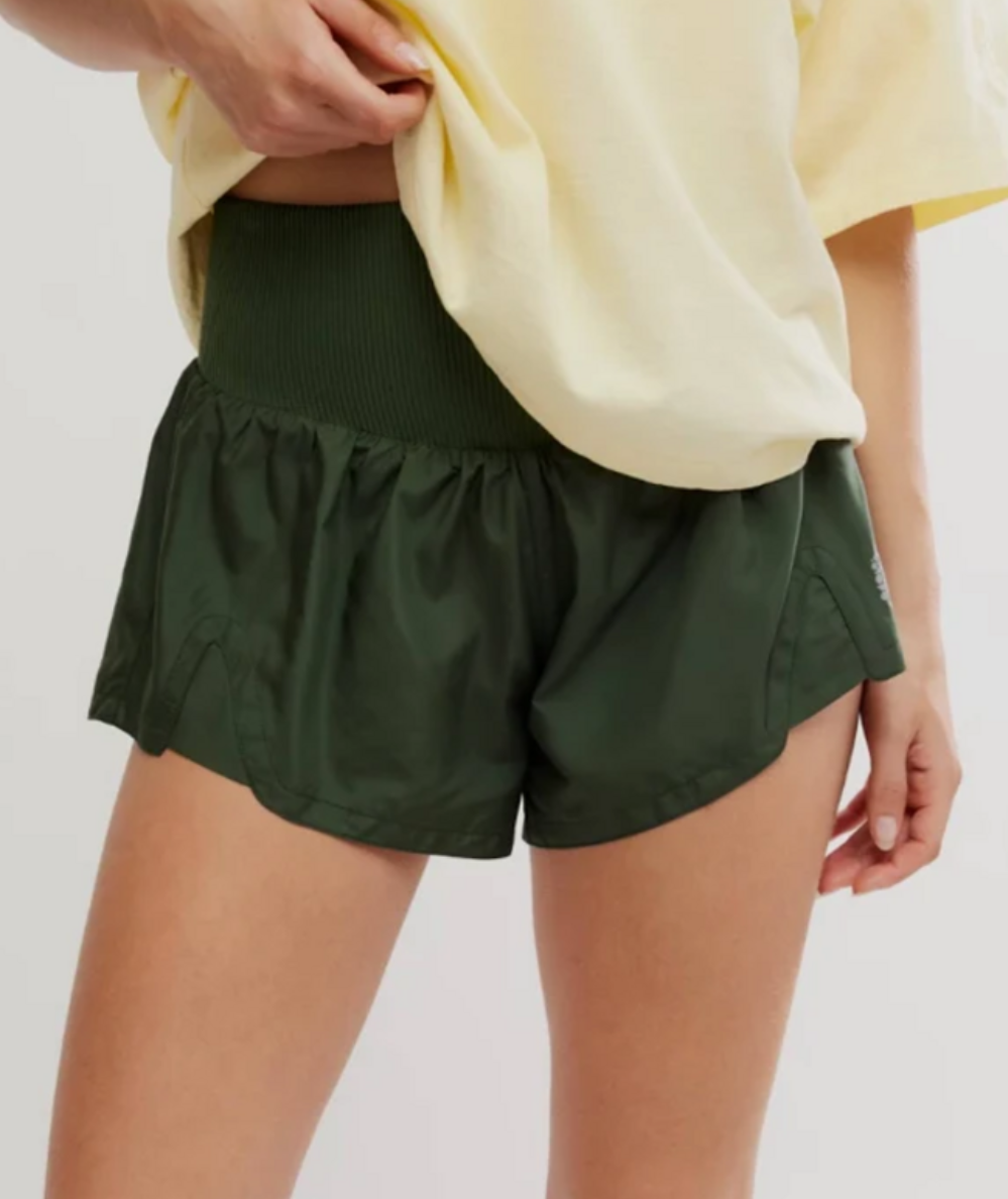 A close-up of a model wearing the FP Movement Carpe Diem Shorts in Ivy