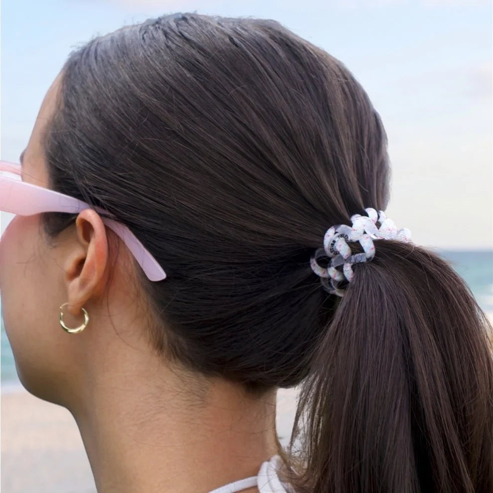 Person with a ponytail and sunglasses, TELETIES Mixed Hair Ties in Pinch Me 5-piece small and large hair tie set