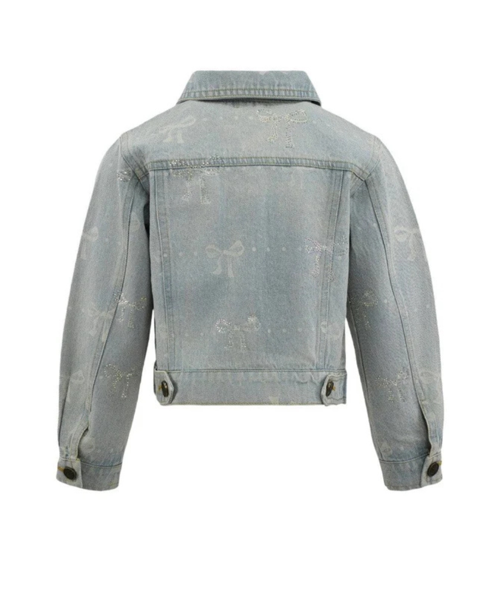 Back view of the Lola & the Boys Tween Denim Sparkle Bow Jacket in light-wash denim with rhinestone bow embellishments and button-front closure.