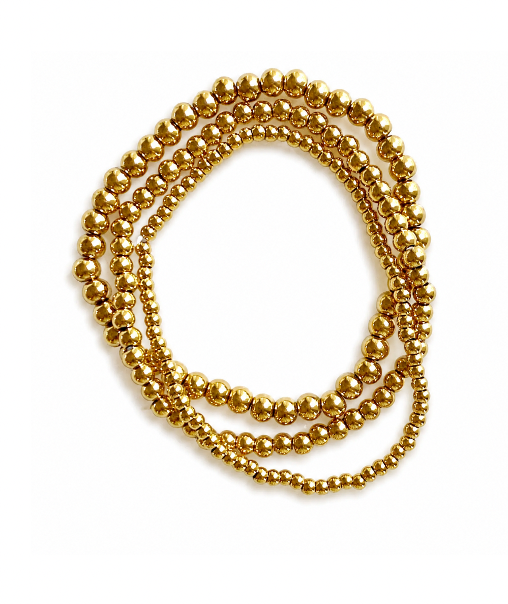 Ellison + Young Keep It Forever set of three 18K gold-plated beaded stretch bracelets in 3 mm, 4 mm and 5 mm sizes.