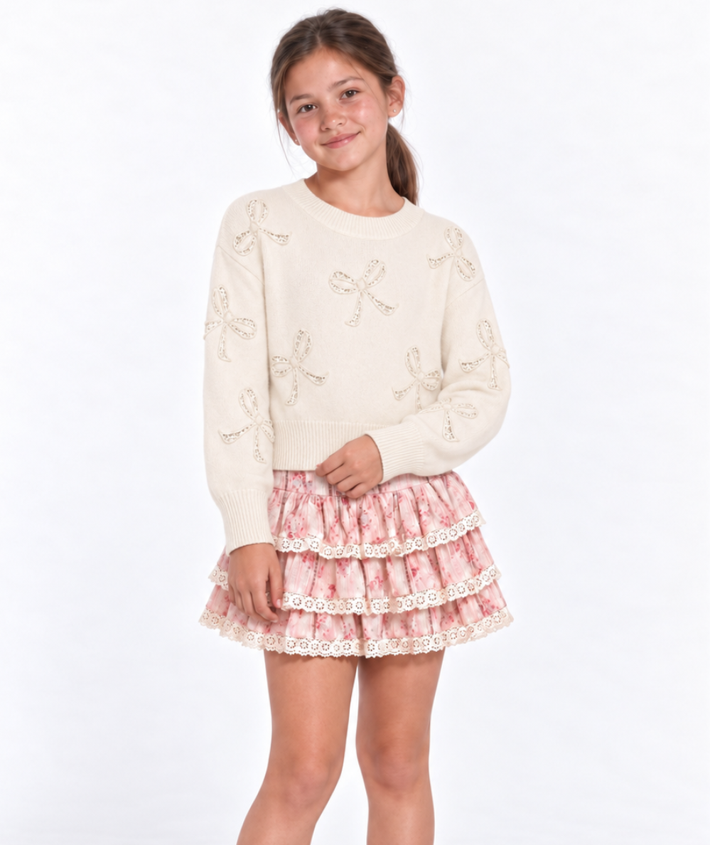 Young model wearing the KatieJ NYC Tween Melody tiered ruffle skirt in blush-pink Rose Stripe Floral print with ivory lace trim