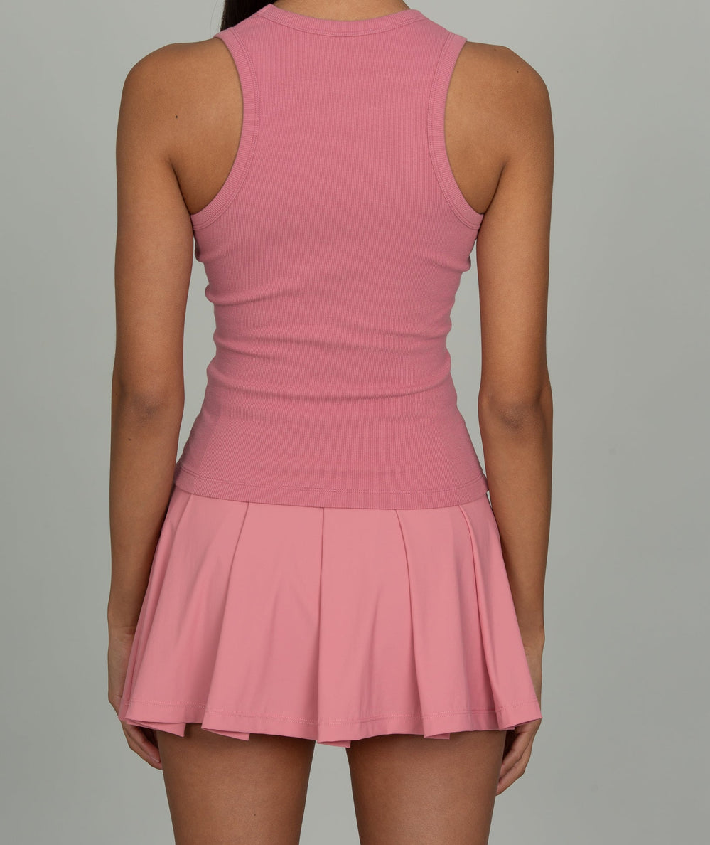 Back view of a model in the Gold Hinge Desert Rose Courtside tennis skirt with a matching pink racerback tank - CAKEWISH.