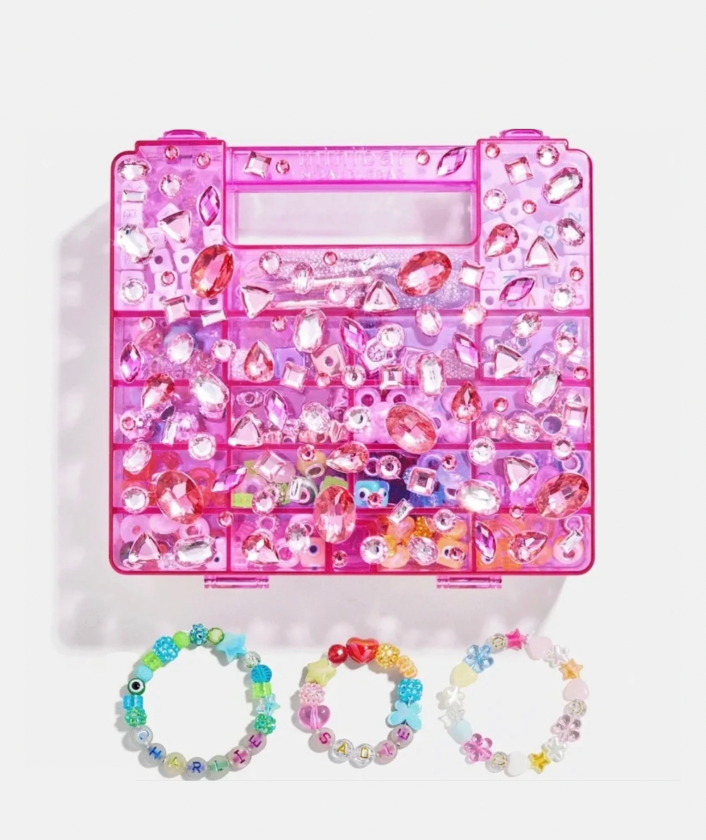 BaubleBar Dream Duo Kids’ DIY bracelet and bag charm kit with gem-covered reusable case In pink. 