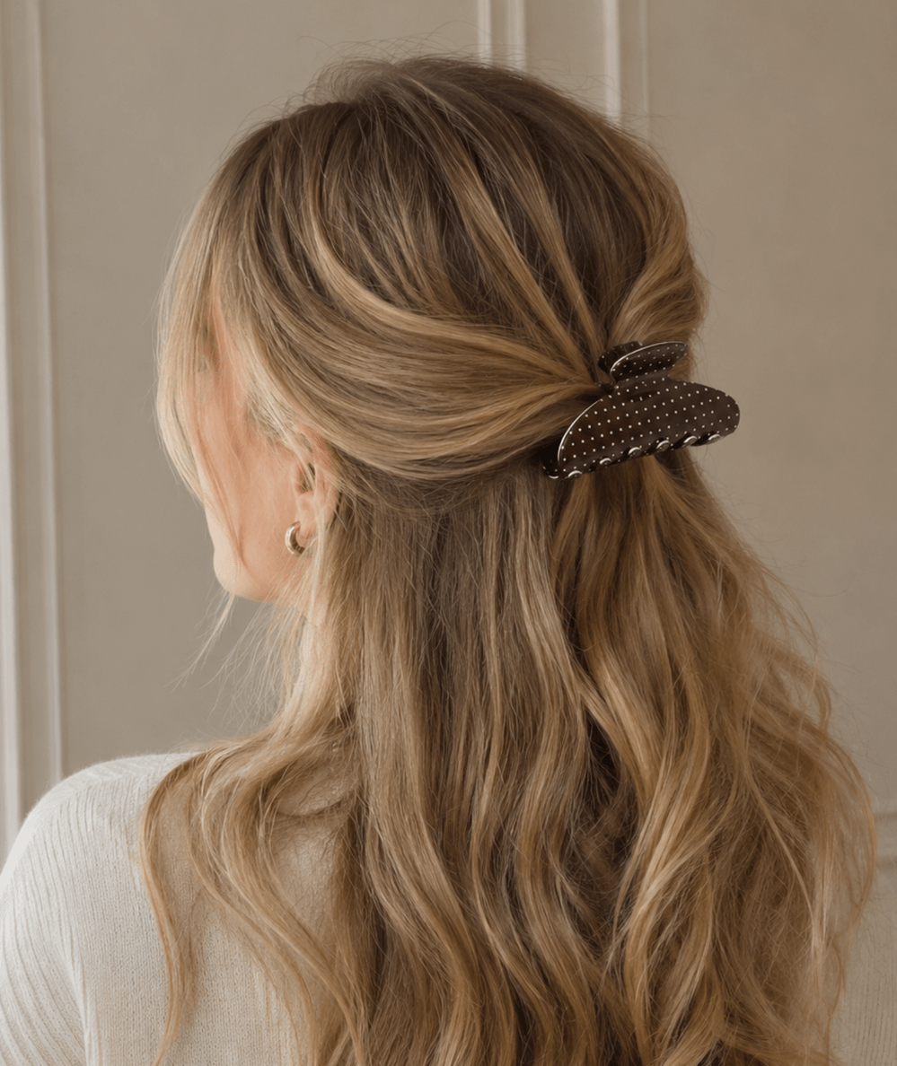 Brown polka dot claw clip holding a half-up hairstyle in long wavy hair by Ellison + Young - CAKEWISH.