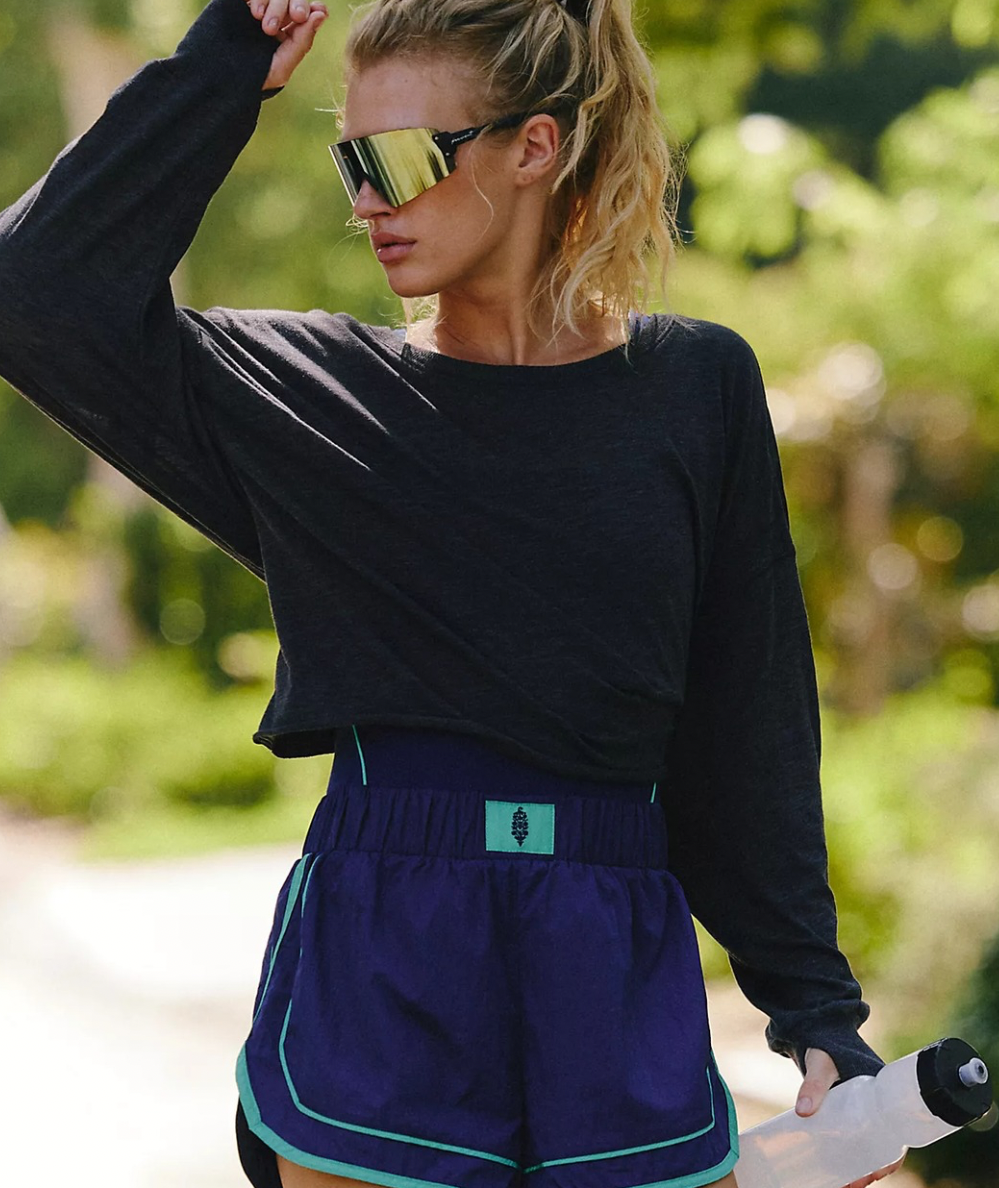 Front view of FP Movement Women’s My Time Long Sleeve Layer Tee in Black with a wide neckline and relaxed cropped fit.