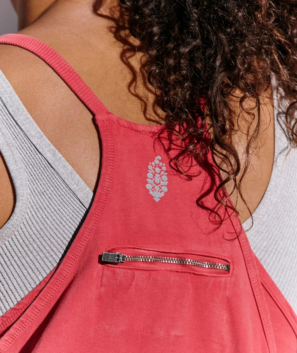 Close-up of the candy apple Free People Movement Hot Shot Mini Dress racerback with a zippered pocket and logo.