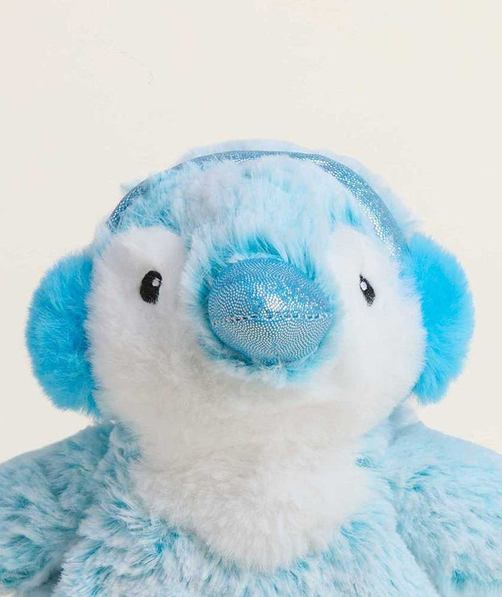 Close-up of the Junior Warmies blue penguin's sweet face and pom-pom earmuffs - CAKEWISH.