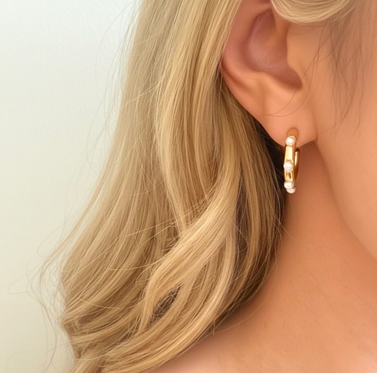 Model wearing the Ellison + Young Pearl Accent Gold Hoop Earrings - CAKEWISH