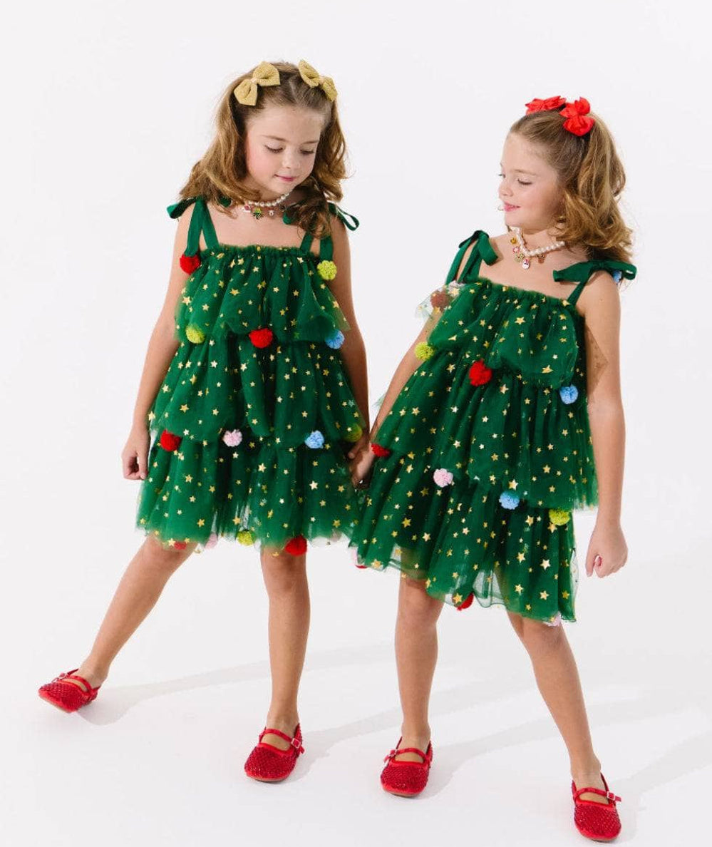 Two girls in green Christmas tree tulle dresses with stars and pom poms by Lola and the Boys - CAKEWISH.
