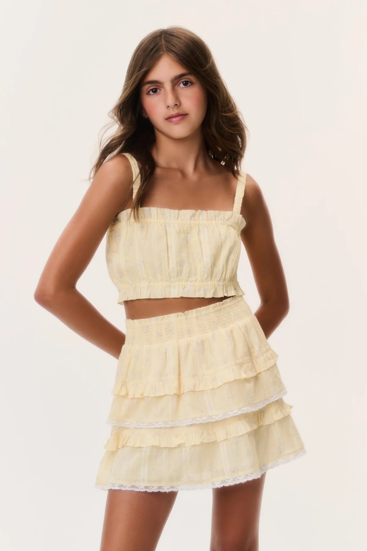 Tween model wearing the LoveShackFancy Tween Ditsy Floral Ken Top with matching skirt