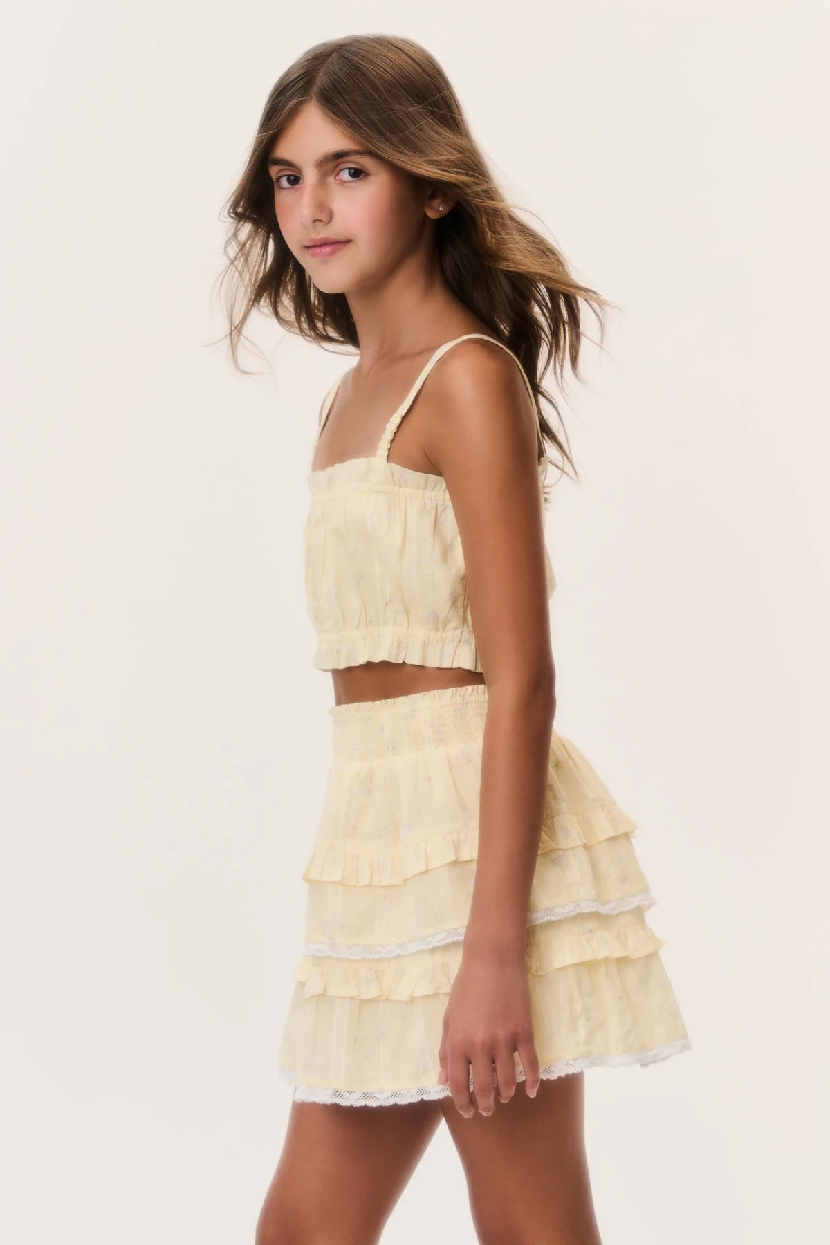 Side view of model wearing the LoveShackFancy Tween Ditsy Floral Ken Top in Lemon Haze