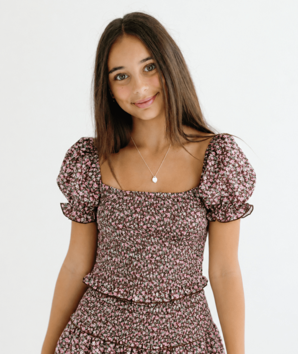 Model wearing the KatieJ NYC Tween Marlee Puff Sleeve Floral Satin Top in Espresso Floral - CAKEWISH