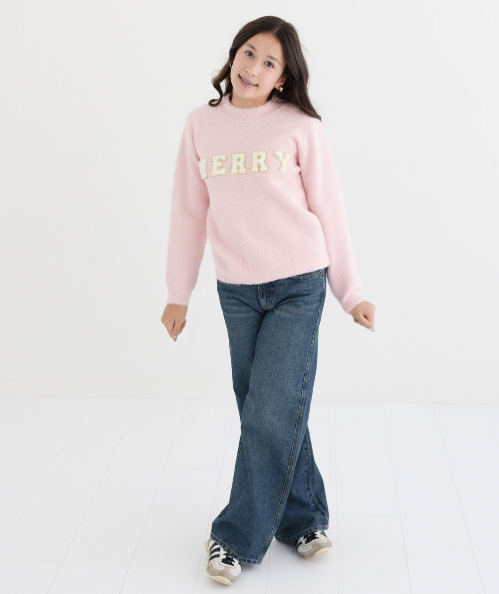 Full-length look of the baby pink fuzzy Merry Pearl Sweater styled with jeans and sneakers by Lola + The Boys - CAKEWISH.