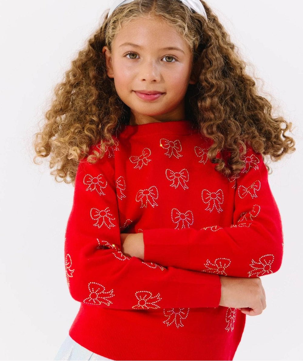 Tween model in the red Lola + The Boys Ruby Crystal Bows Sweater - CAKEWISH