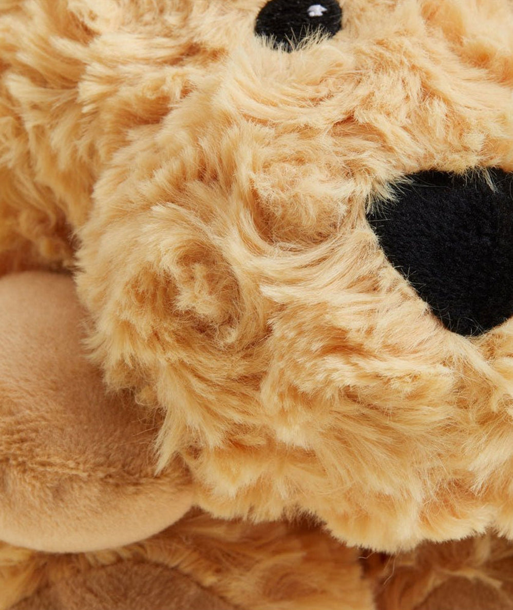Close-up of the curly golden plush fur and black nose on the Warmies dog wrap - CAKEWISH.